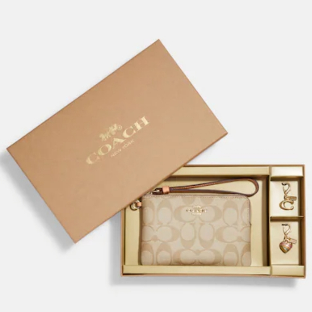 Coach boxed corner zip wristlet in signature canvas with charms